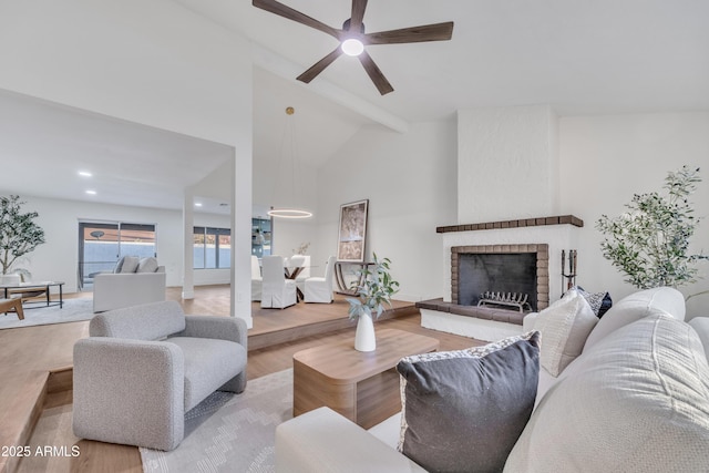 living room featuring a brick fireplace, a ceiling fan, recessed lighting, wood finished floors, and vaulted ceiling