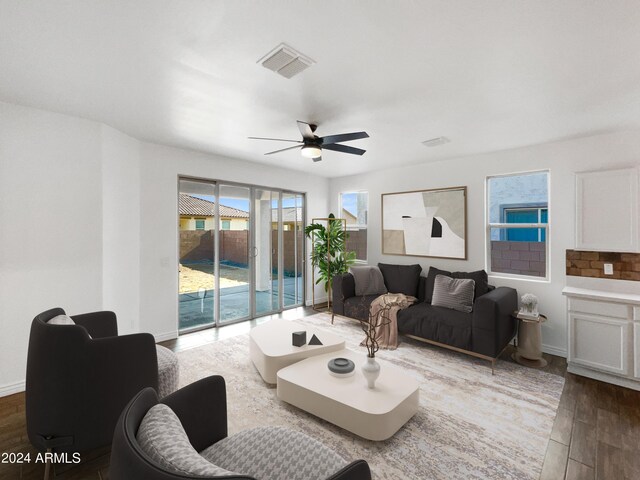 living room featuring ceiling fan and hardwood / wood-style floors