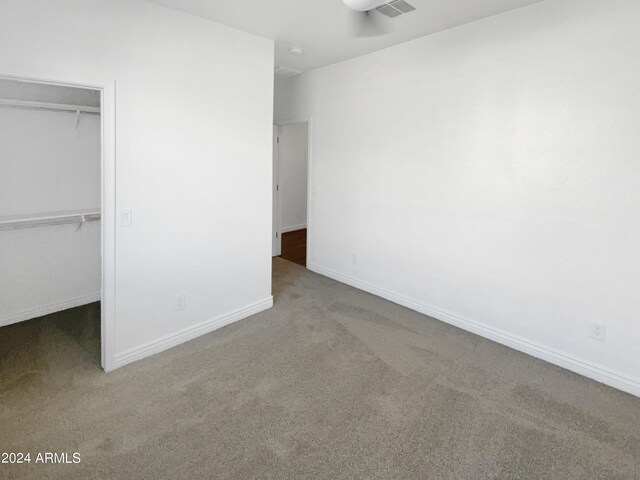 unfurnished bedroom with carpet flooring and a closet