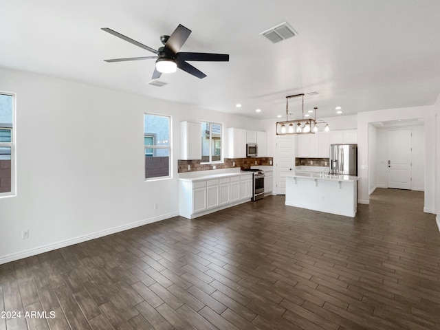 unfurnished living room with ceiling fan and dark hardwood / wood-style floors