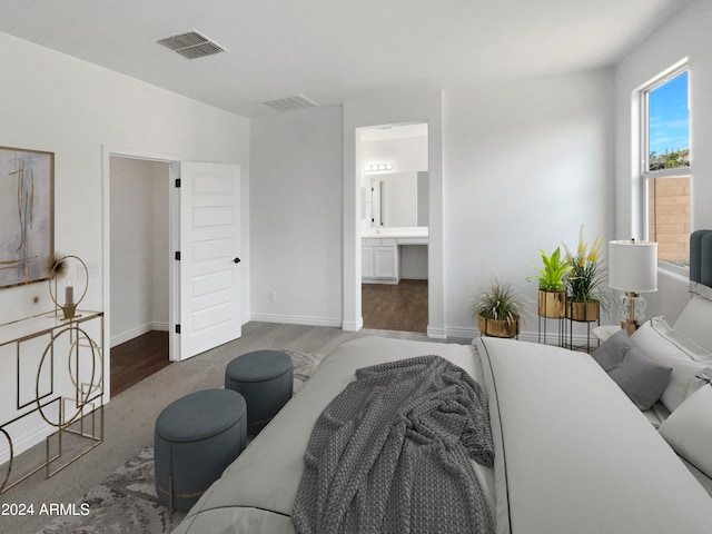 bedroom featuring wood-type flooring and connected bathroom