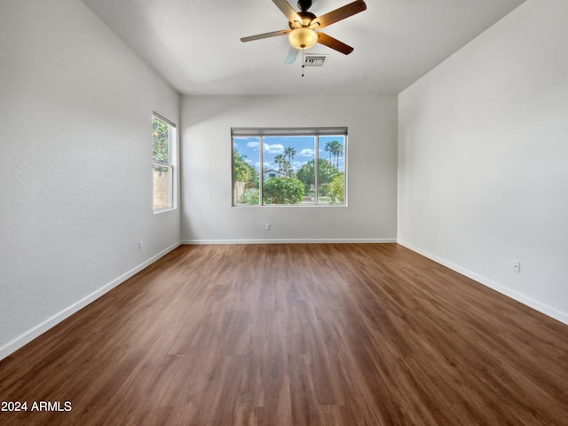 empty room with ceiling fan and dark wood-type flooring