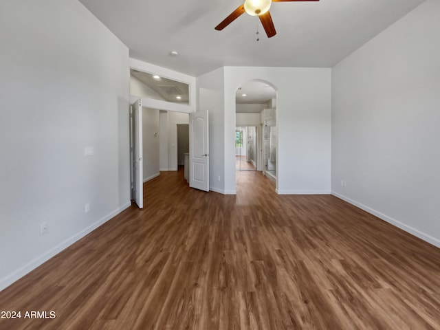 unfurnished living room featuring dark hardwood / wood-style flooring and ceiling fan