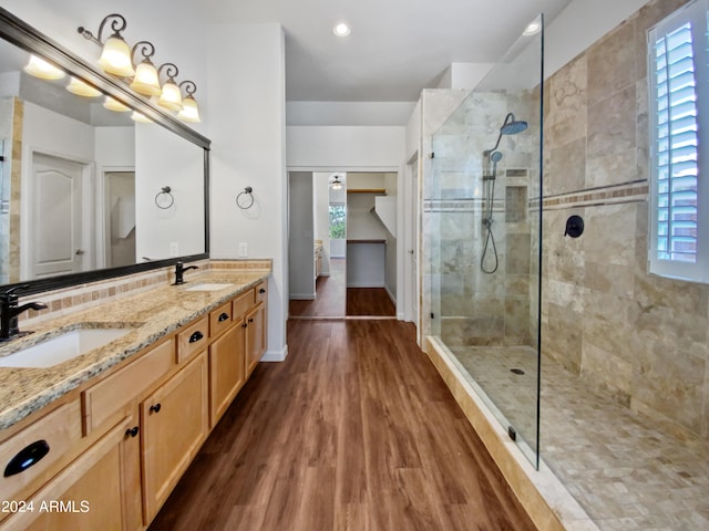 bathroom featuring hardwood / wood-style floors, plenty of natural light, and tiled shower