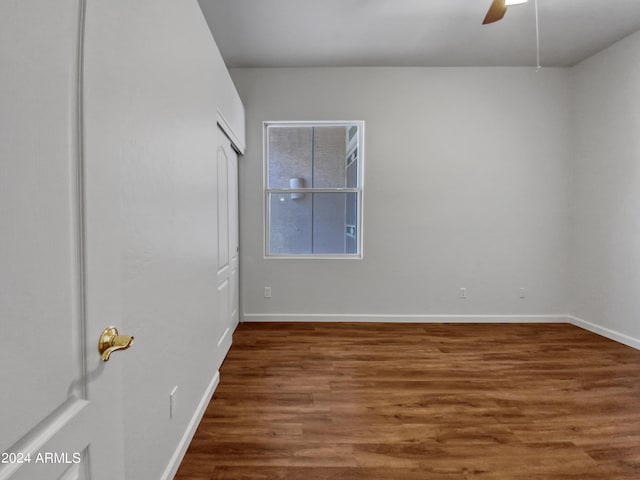 empty room featuring ceiling fan and dark hardwood / wood-style flooring