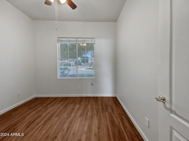 empty room with ceiling fan and hardwood / wood-style flooring