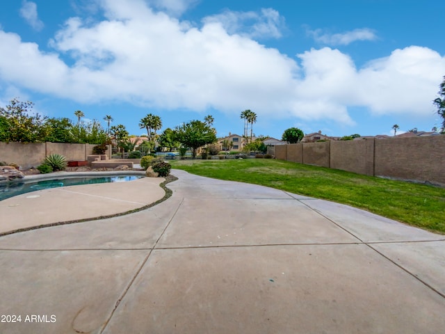 view of pool with a yard and a patio