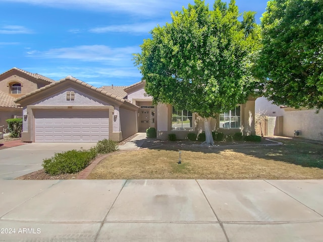 view of front of house with a garage and a front lawn