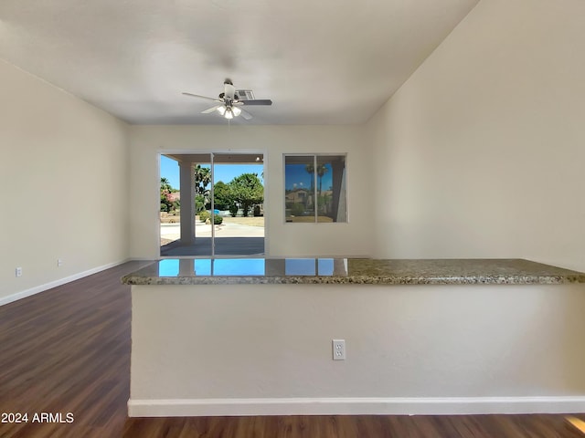 unfurnished room featuring dark hardwood / wood-style flooring and ceiling fan