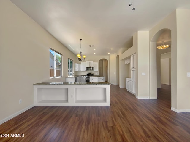 kitchen with kitchen peninsula, white cabinetry, dark hardwood / wood-style flooring, and appliances with stainless steel finishes