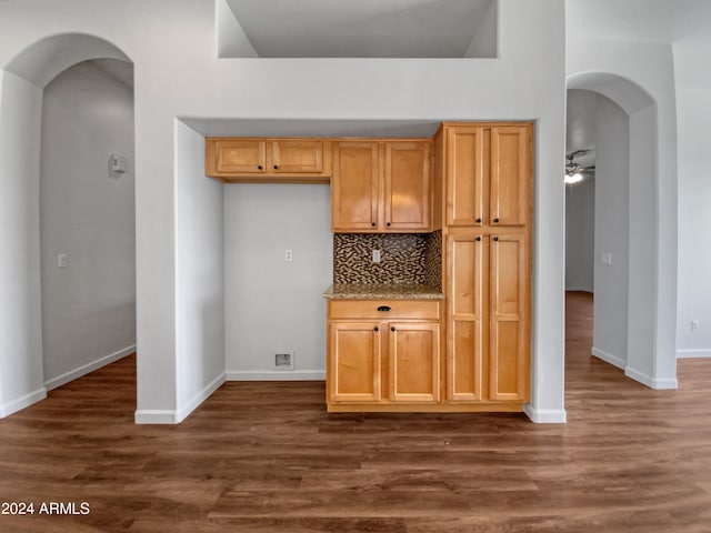 kitchen with light brown cabinetry, tasteful backsplash, ceiling fan, and dark wood-type flooring