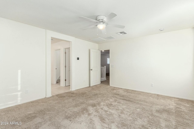 unfurnished room with light carpet and ceiling fan