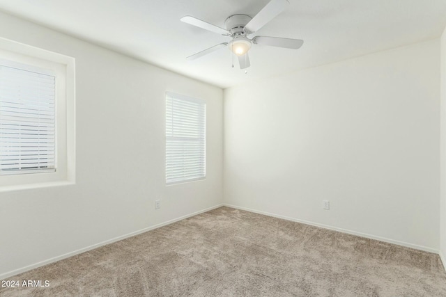 empty room with light carpet and ceiling fan