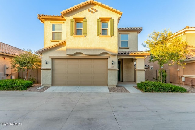 mediterranean / spanish house featuring a garage