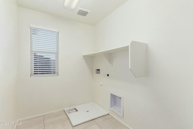 clothes washing area featuring washer hookup, light tile patterned floors, gas dryer hookup, and electric dryer hookup