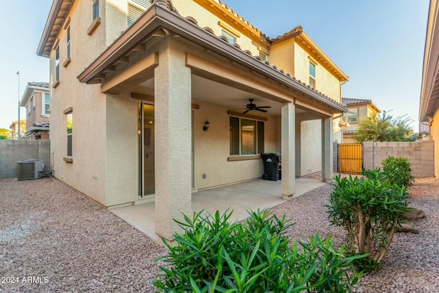 back of property with ceiling fan, cooling unit, and a patio area