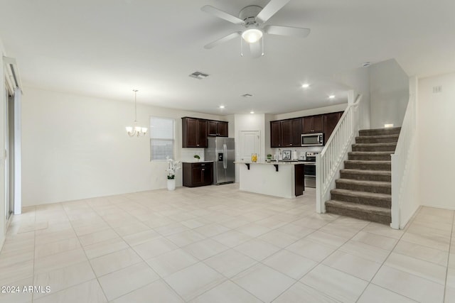 unfurnished living room with light tile patterned floors and ceiling fan with notable chandelier