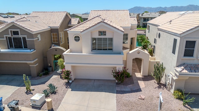 view of front of property with a mountain view and a garage