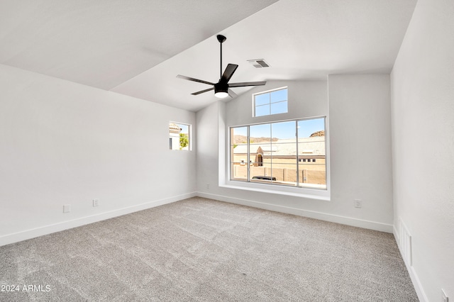 empty room with ceiling fan, carpet, and vaulted ceiling