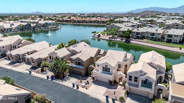 drone / aerial view with a water and mountain view