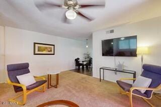 living room with ceiling fan and carpet floors