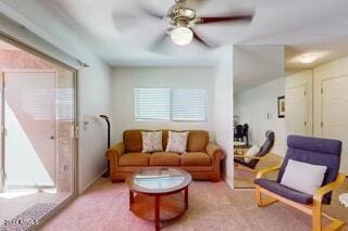 living room with ceiling fan and light colored carpet