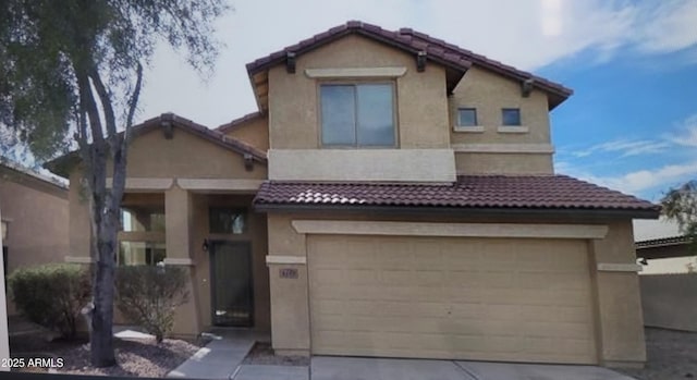 view of front facade featuring an attached garage, stucco siding, concrete driveway, and a tile roof