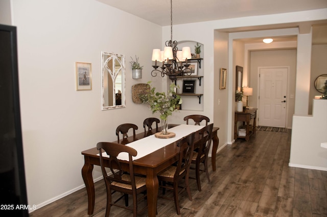 dining space with an inviting chandelier and dark hardwood / wood-style floors