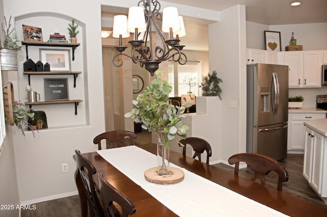 dining area featuring dark hardwood / wood-style floors and a chandelier