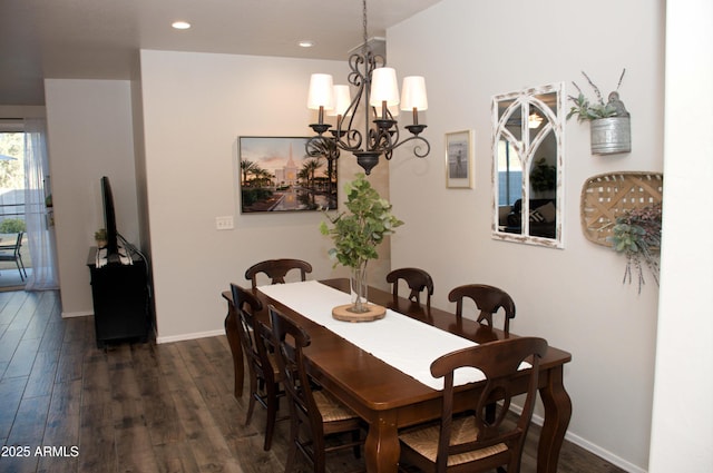 dining space featuring dark wood-type flooring and a notable chandelier