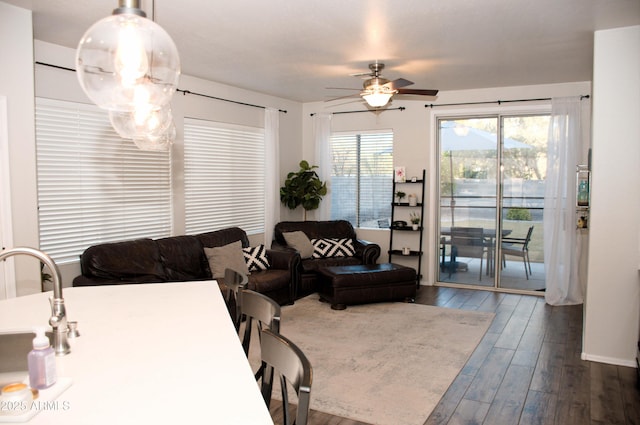 living room with ceiling fan, sink, and hardwood / wood-style floors