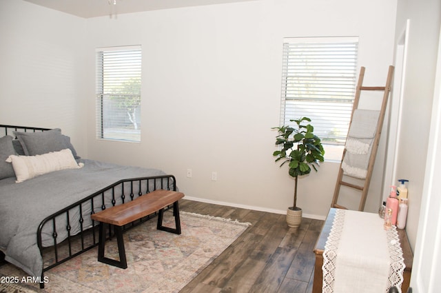 bedroom with dark wood-type flooring