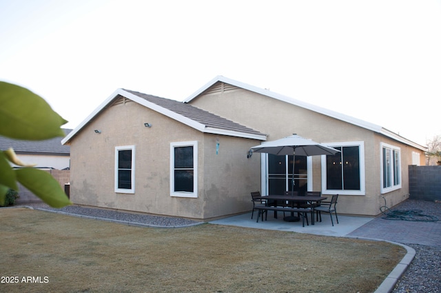 back of property featuring a yard and a patio area