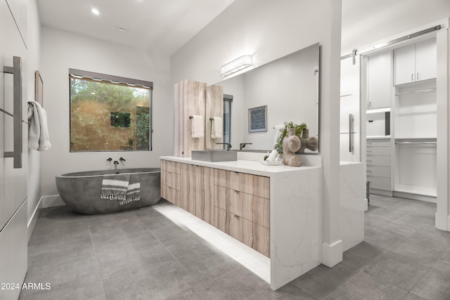 bathroom featuring vanity and a washtub