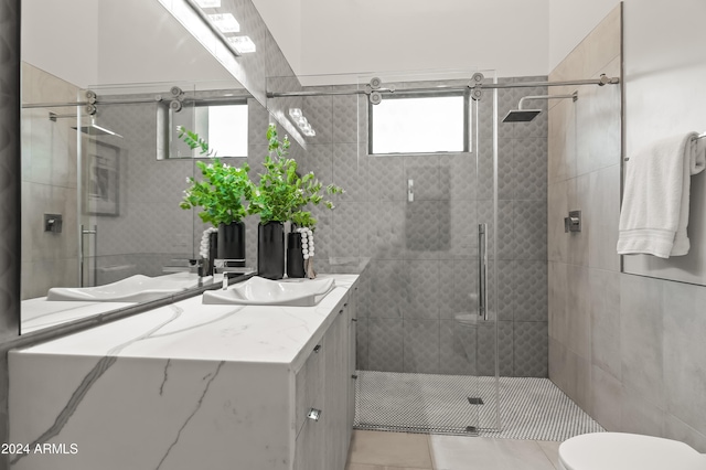 bathroom featuring vanity, toilet, tile patterned floors, and a shower with door