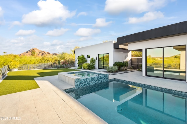 view of pool featuring a yard, a mountain view, an in ground hot tub, and a patio