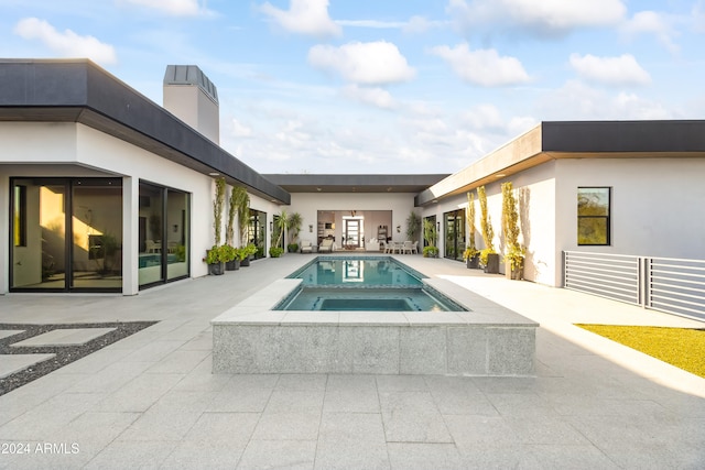 view of swimming pool featuring a patio and an in ground hot tub