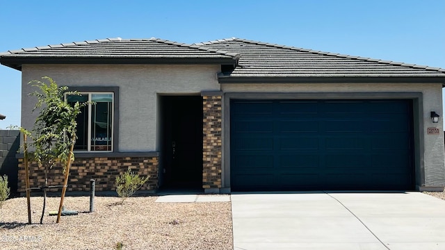 25133 W Wayland Dr, Buckeye, AZ 85326 - prairie-style house with a garage, stucco siding, driveway, a tile roof, and stone siding