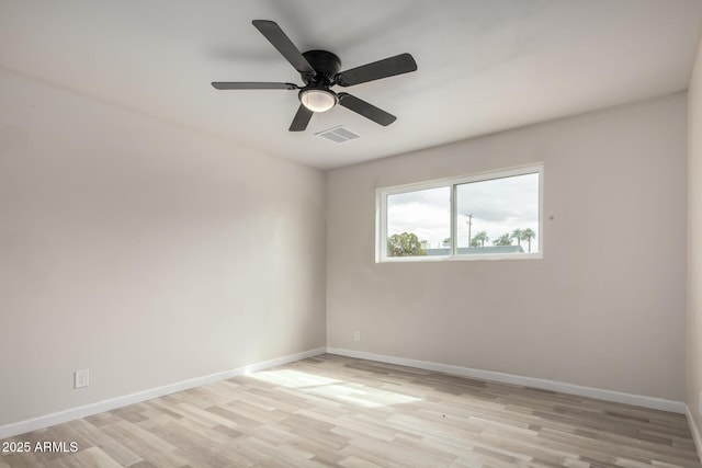 unfurnished room with ceiling fan, visible vents, baseboards, and light wood-style flooring