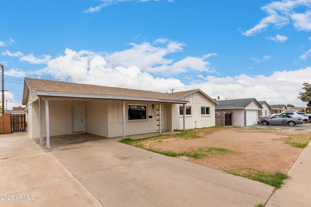 single story home with a carport, concrete driveway, a gate, and fence