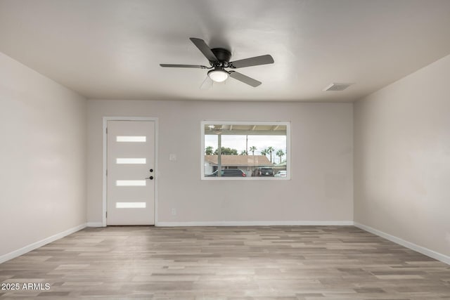 foyer featuring a ceiling fan, visible vents, light wood-style floors, and baseboards