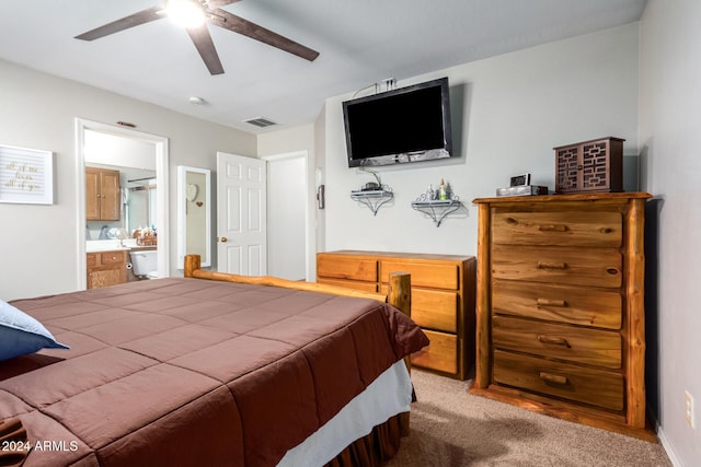 carpeted bedroom with ceiling fan and ensuite bathroom