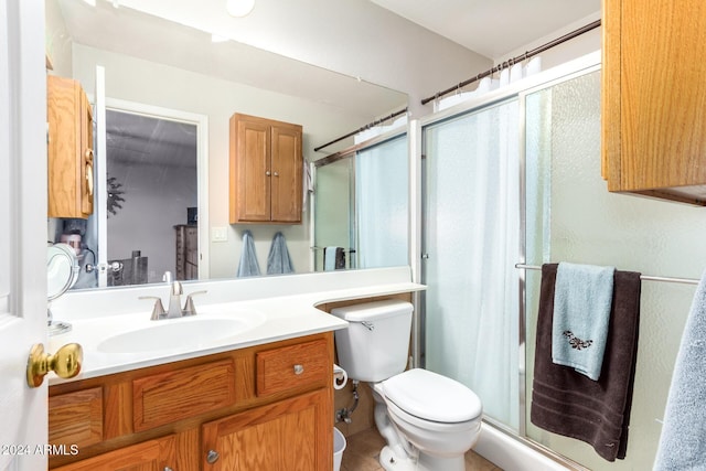 bathroom featuring vanity, toilet, and walk in shower