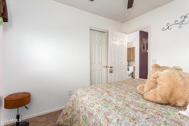 carpeted bedroom with a closet, ensuite bathroom, and ceiling fan