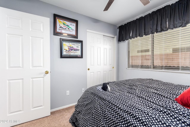 carpeted bedroom featuring a closet and ceiling fan