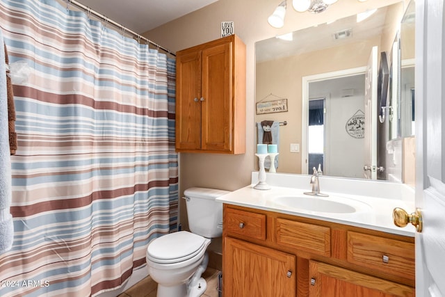 bathroom with tile patterned flooring, vanity, and toilet