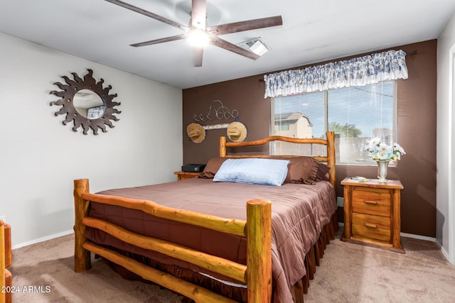 bedroom with ceiling fan and light carpet