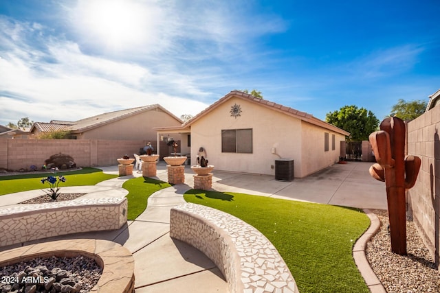 rear view of property with central AC unit and a patio