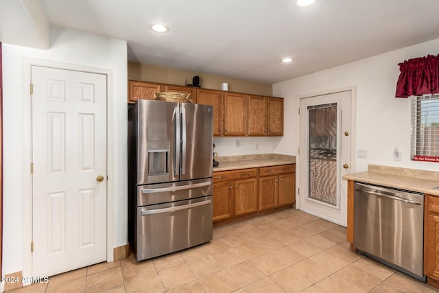 kitchen featuring appliances with stainless steel finishes and light tile patterned floors