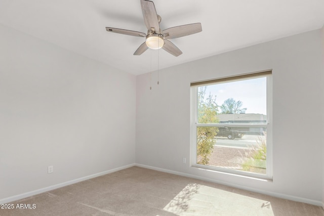 carpeted spare room with ceiling fan